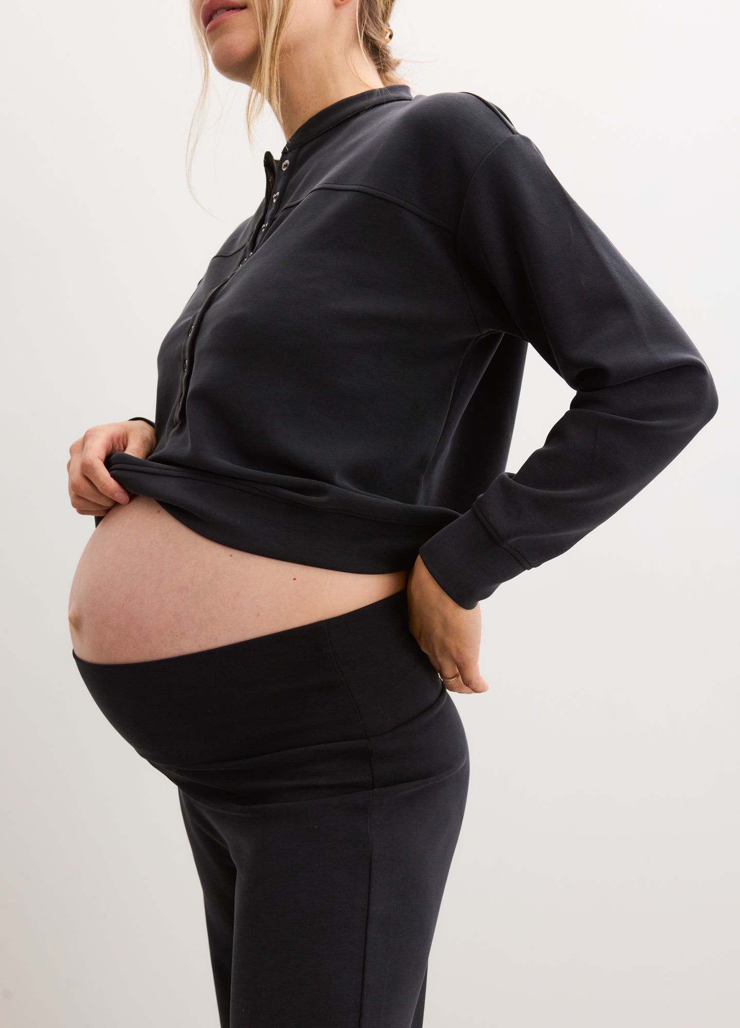 Black maternity jogger pants with a high, stretchy over-under waistband for pregnancy comfort.