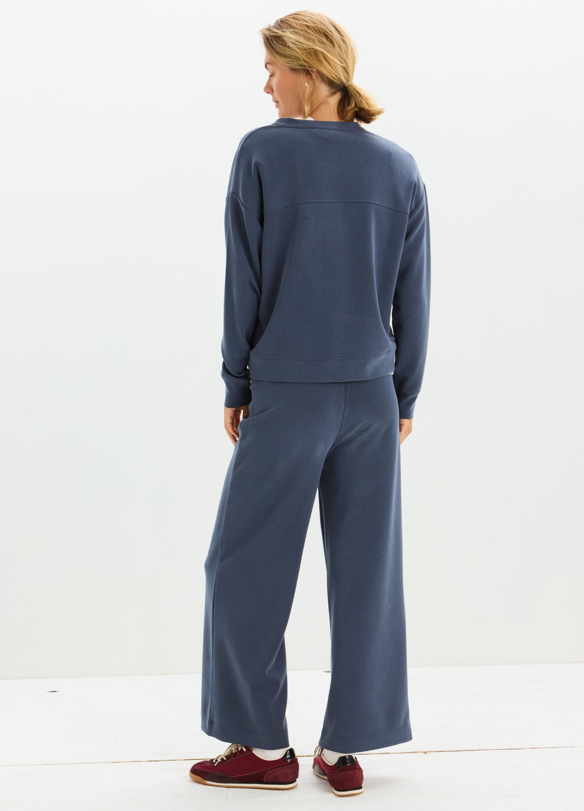 Navy blue soft knit maternity pullover with matching wide-leg pants, relaxed fit for pregnancy comfort.