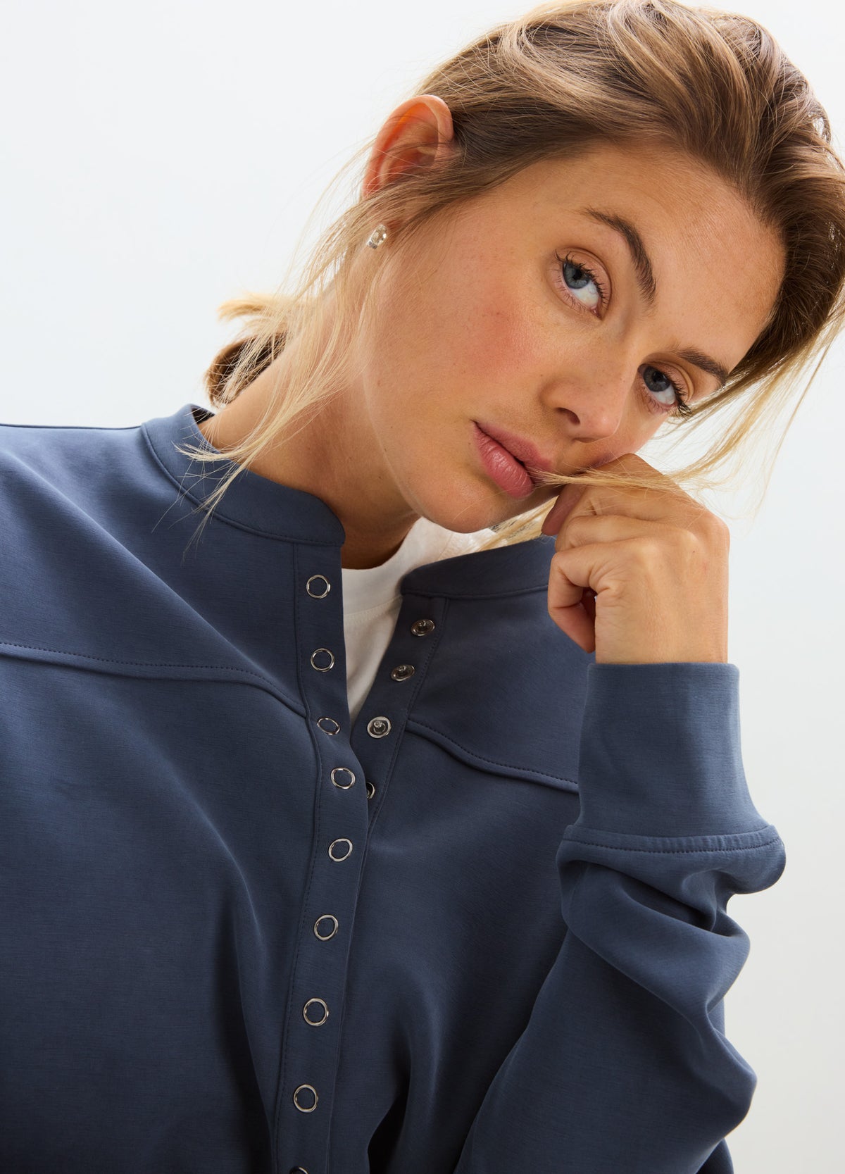 Maternity blue-gray nursing pullover with snap-button front and relaxed fit on model.