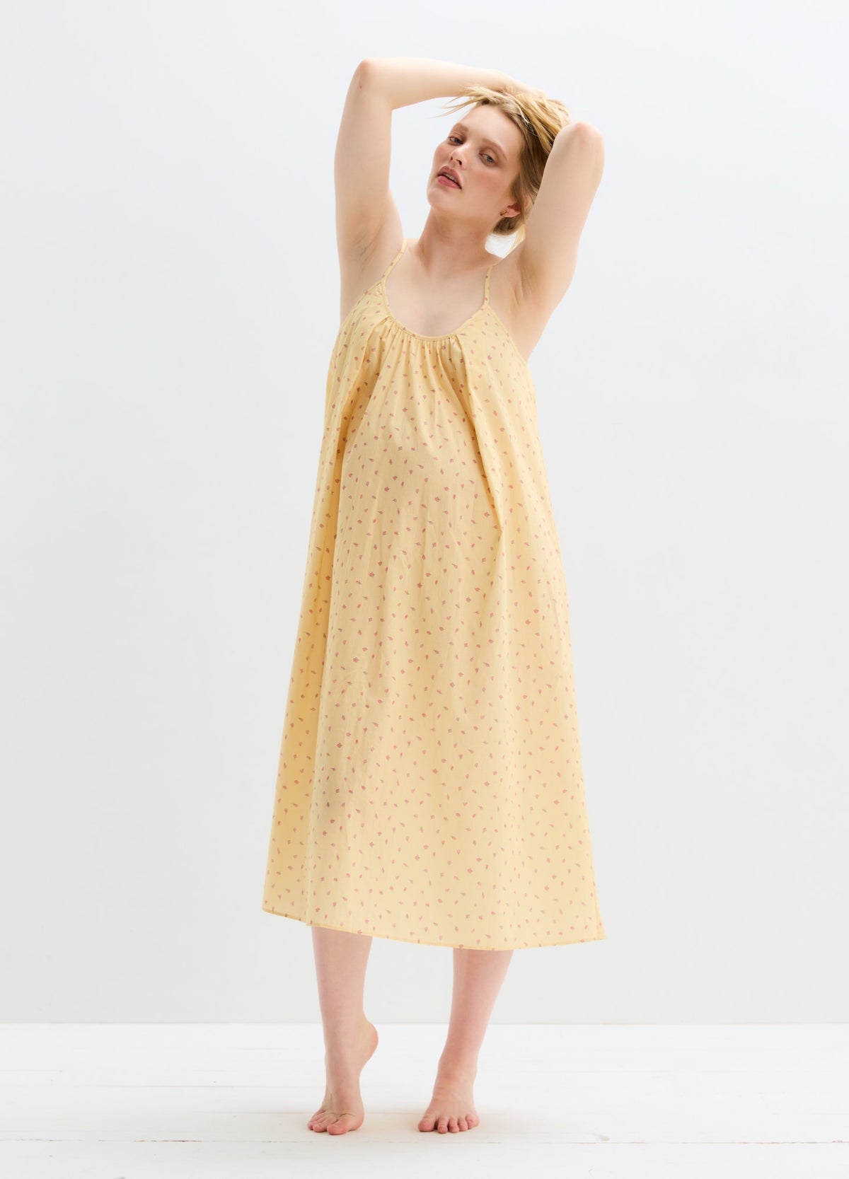 Sleeveless maternity nursing nightgown in soft yellow cotton with small floral print and loose fit.