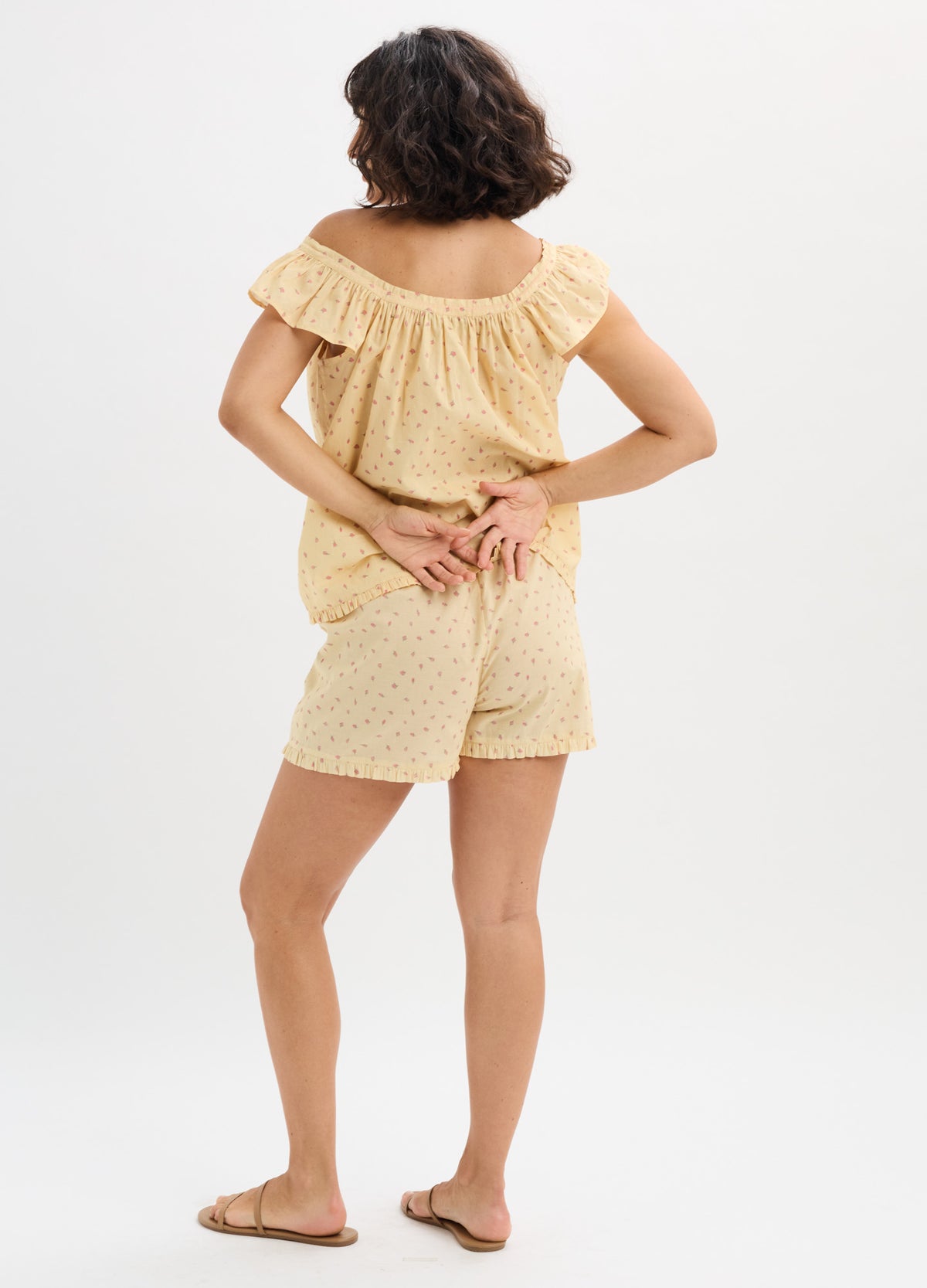 Light yellow cotton nursing tank top with ruffled off-shoulder sleeves and matching shorts with subtle polka dots.