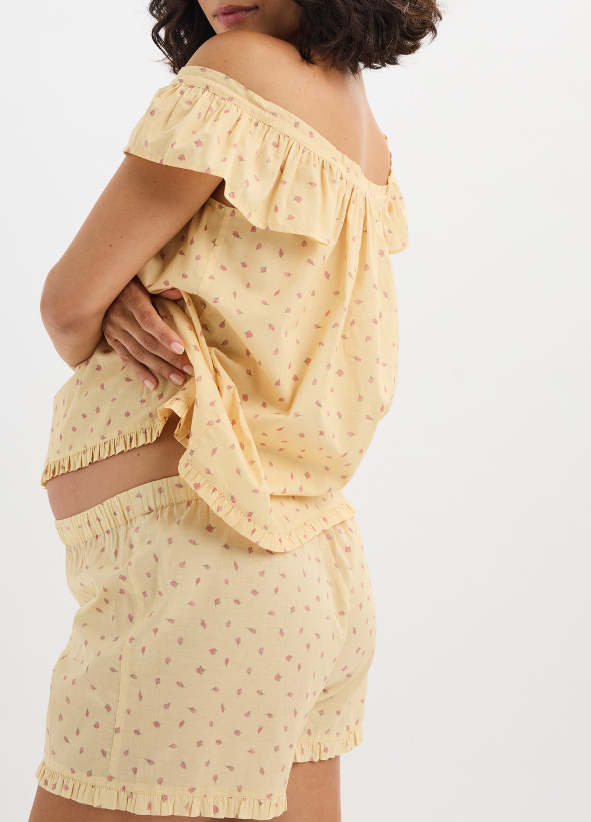 Yellow cotton nursing pajama set with small floral print, off-shoulder ruffle tank and elastic waistband shorts.