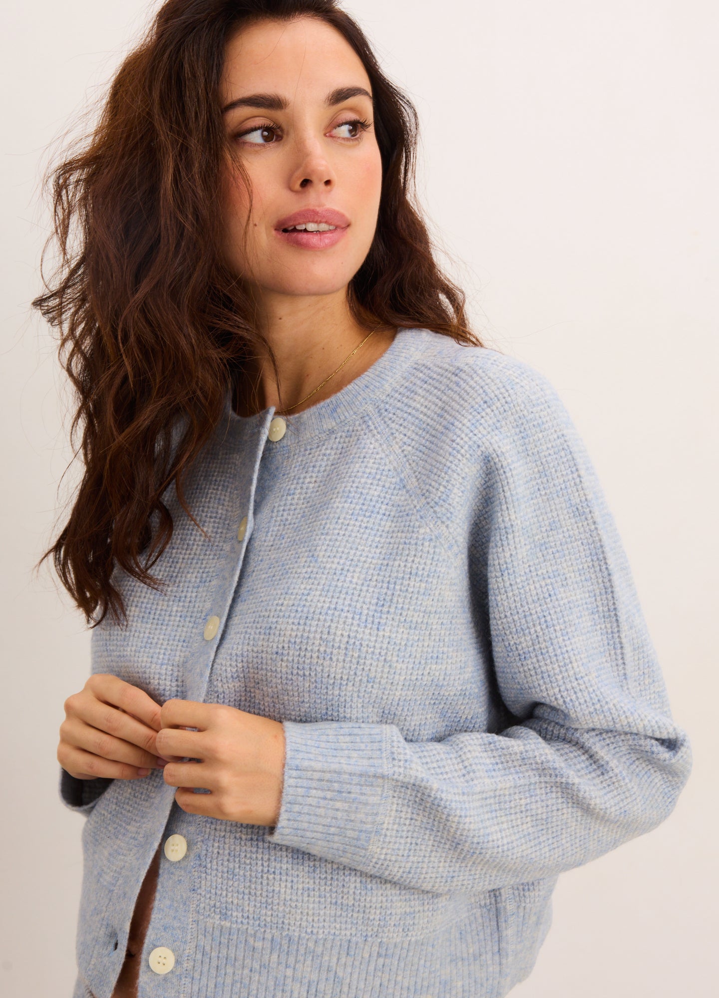 Light blue waffle-knit cardigan with long sleeves and pearl buttons, maternity fit.