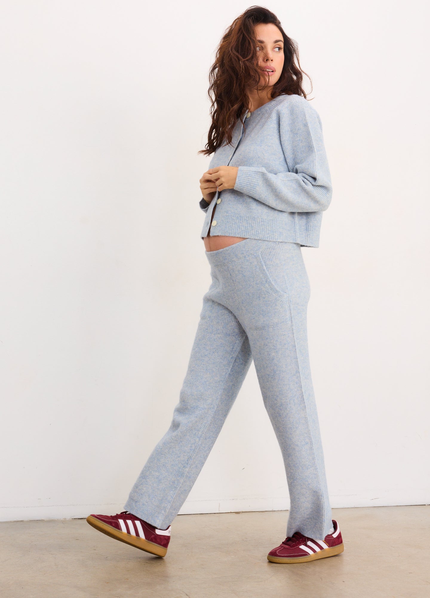 Light blue waffle-knit maternity crop pants with a relaxed fit worn by a pregnant model.