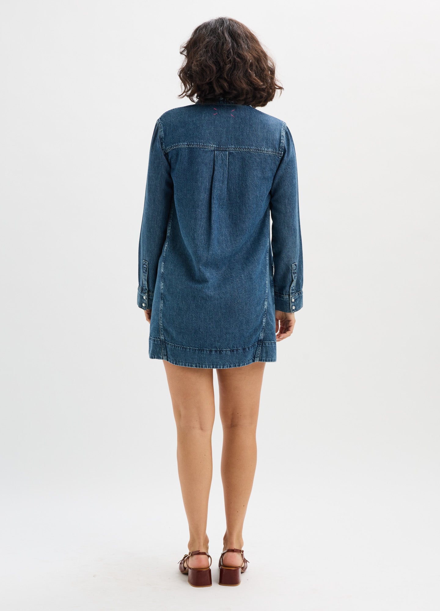 Dark blue denim mini dress with long sleeves and relaxed fit, designed for maternity wear.