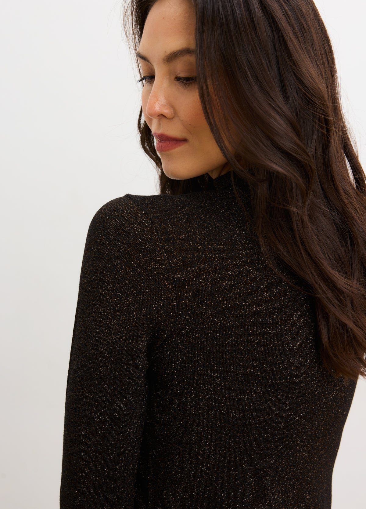 Black metallic knit mini dress with long sleeves and fitted silhouette, designed for maternity wear.