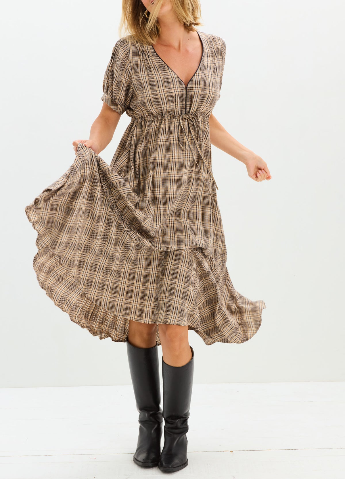 Plaid maternity nursing dress with V-neck, short puff sleeves, and flowy ankle-length skirt in beige and brown tones.