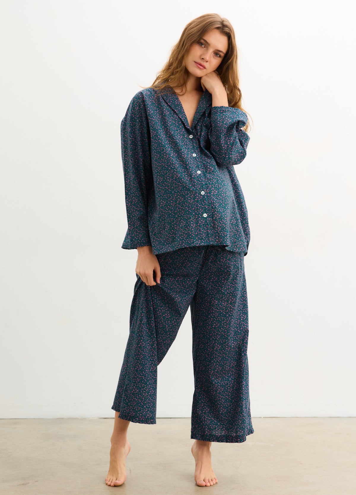 Maternity ruffle pajama set in dark blue with subtle floral print, button-front top and loose pants for pregnant comfort.