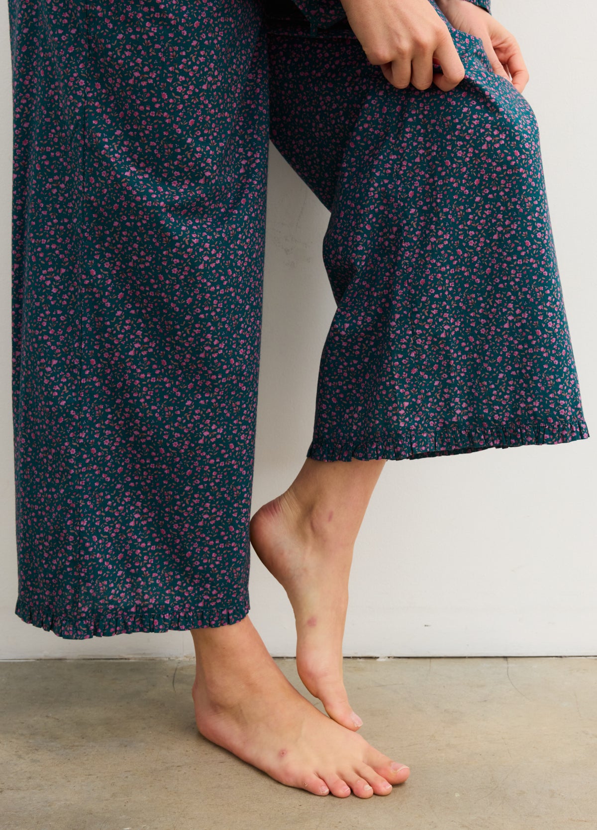 Navy blue maternity pajama pants with small floral print and ruffled hems, loose fit for comfort.