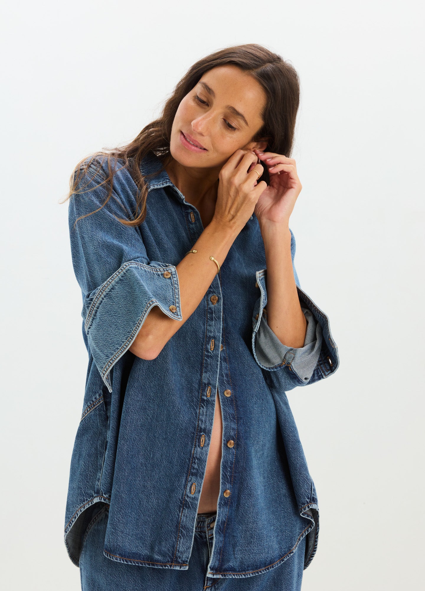 Maternity drapey denim boyfriend shirt with rolled-up sleeves and button-down front.