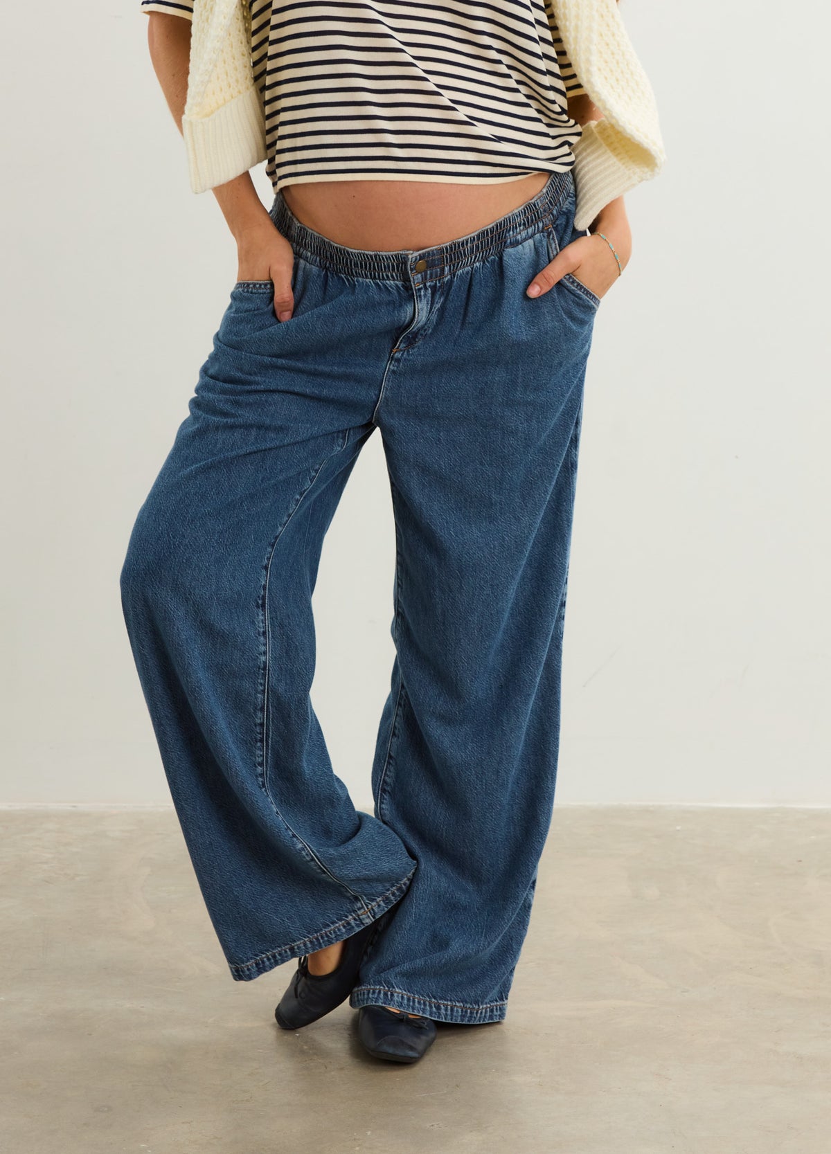 Dark blue wide-leg maternity denim pants with elastic waistband and front pockets.
