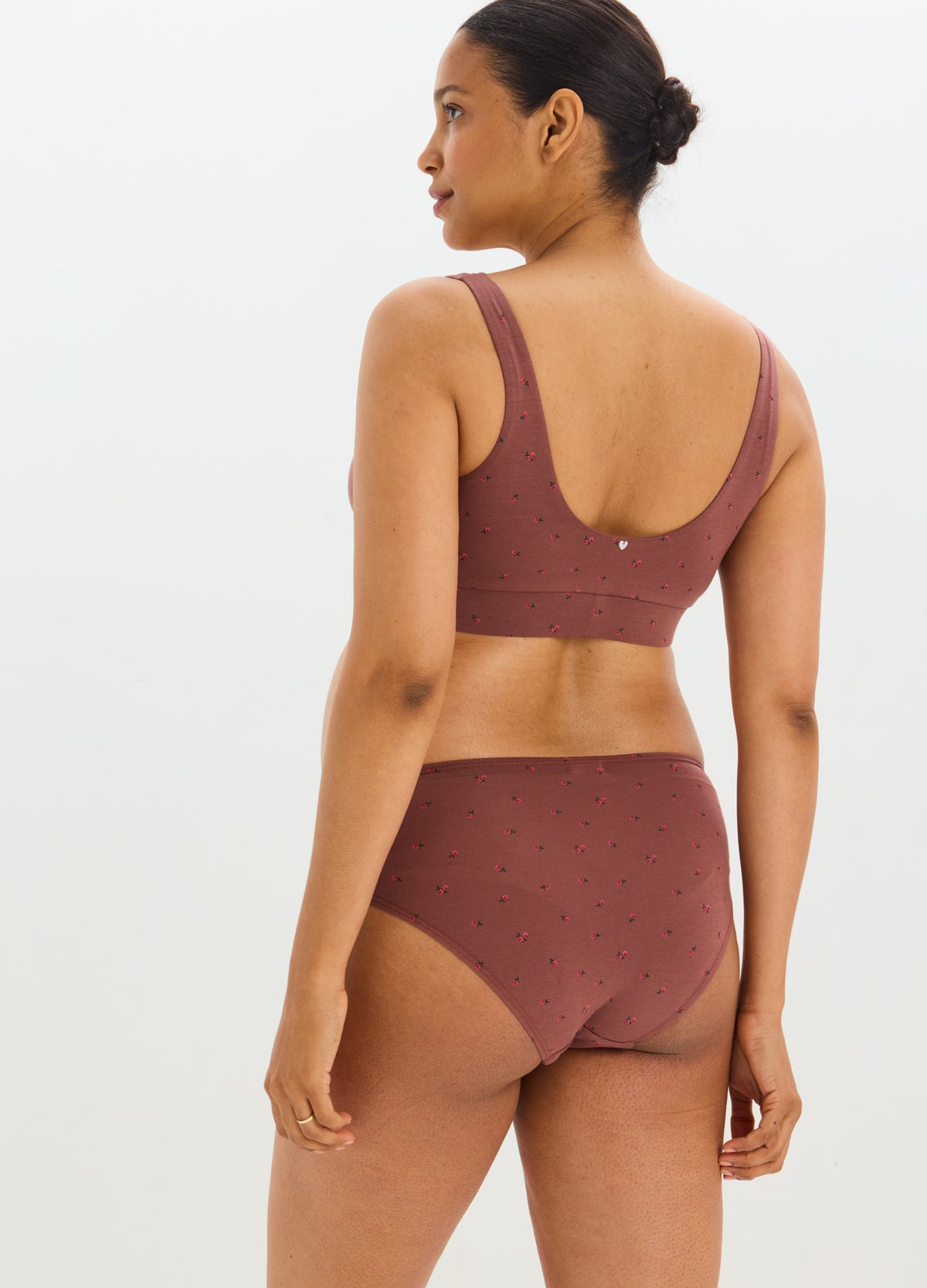 Mauve seamless nursing and sleep bra with wide straps and soft fabric on a pregnant model.