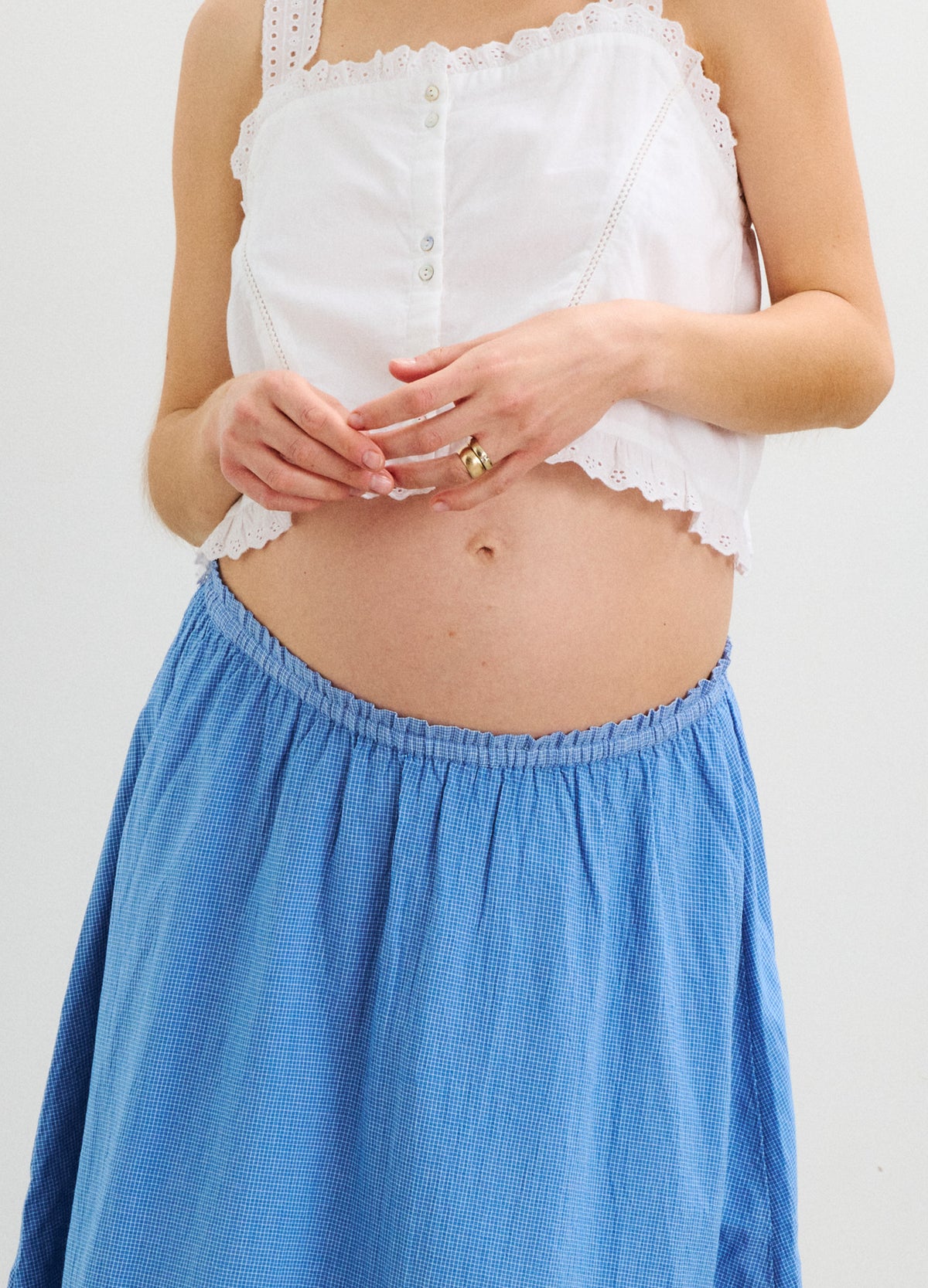Light blue maternity skirt with gathered elastic waistband, soft flowing fabric.