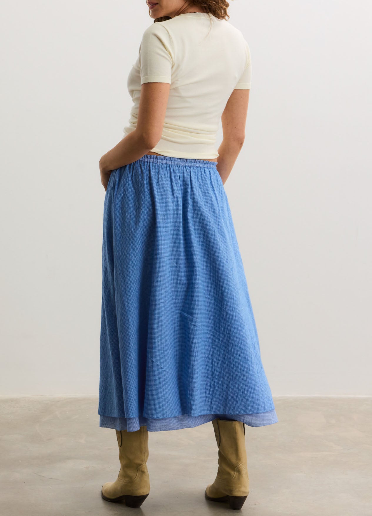 Blue maternity skirt with elastic waistband, flowing midi length, soft lightweight fabric.