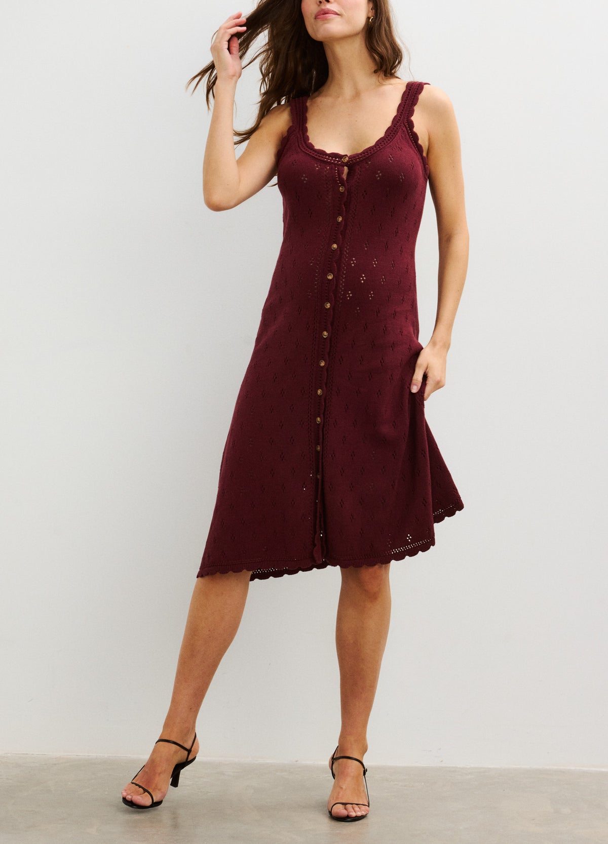 Sleeveless burgundy maternity nursing tank dress with button-front and scalloped edges.