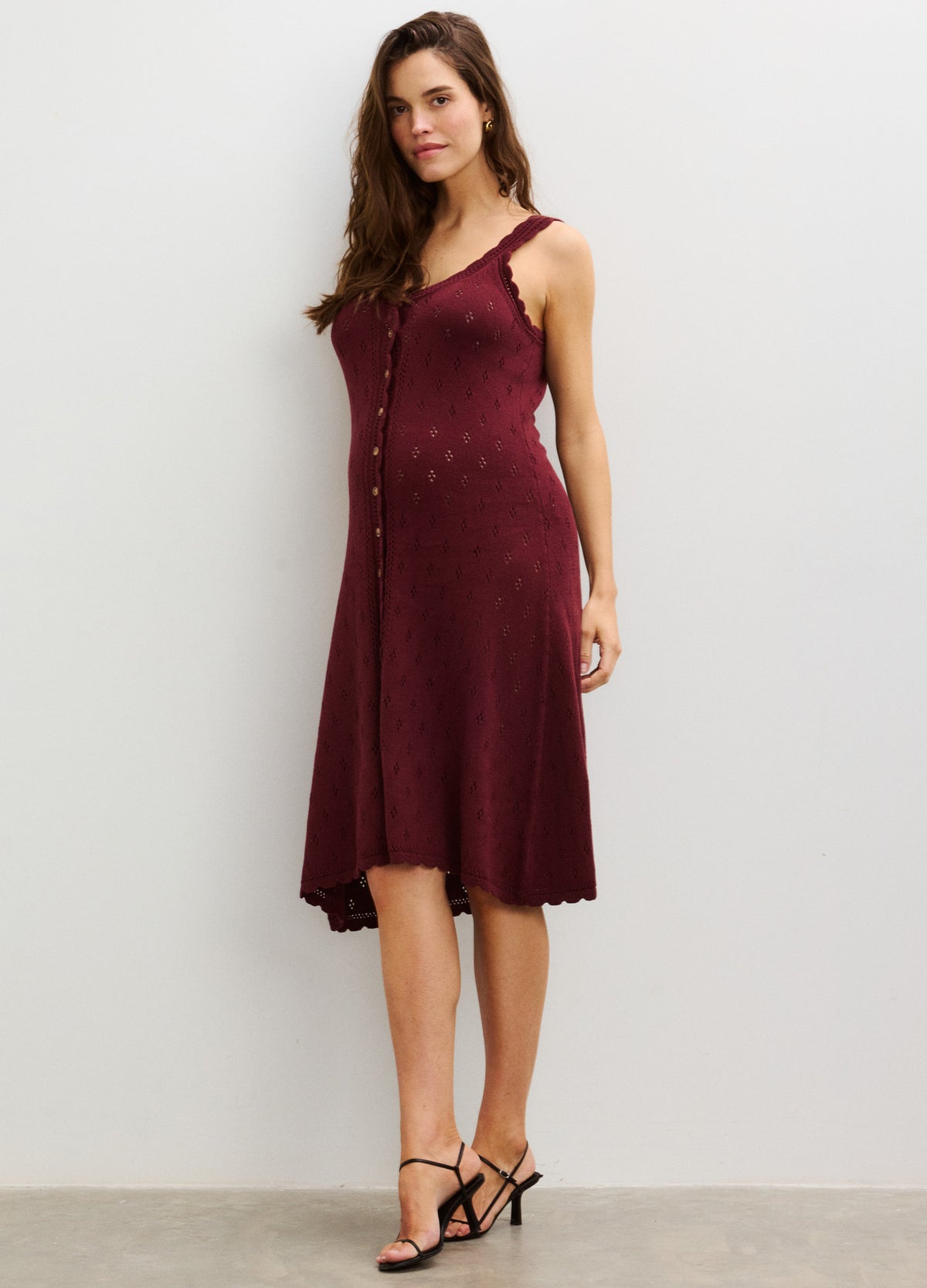 Sleeveless burgundy pointelle knit nursing tank dress with button front and flared hem, designed for maternity and pregnancy.