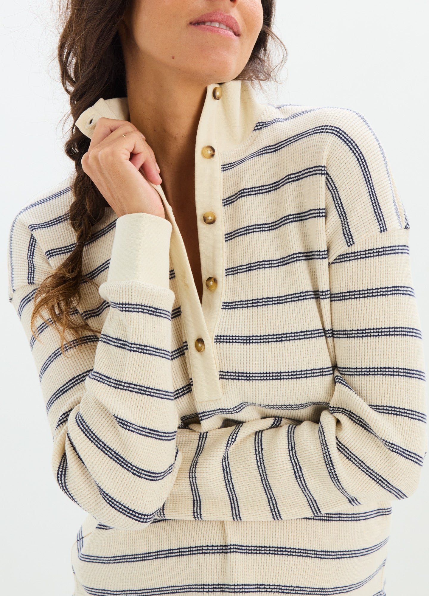 Cream and navy striped waffle knit nursing top with button-up collar and long sleeves.