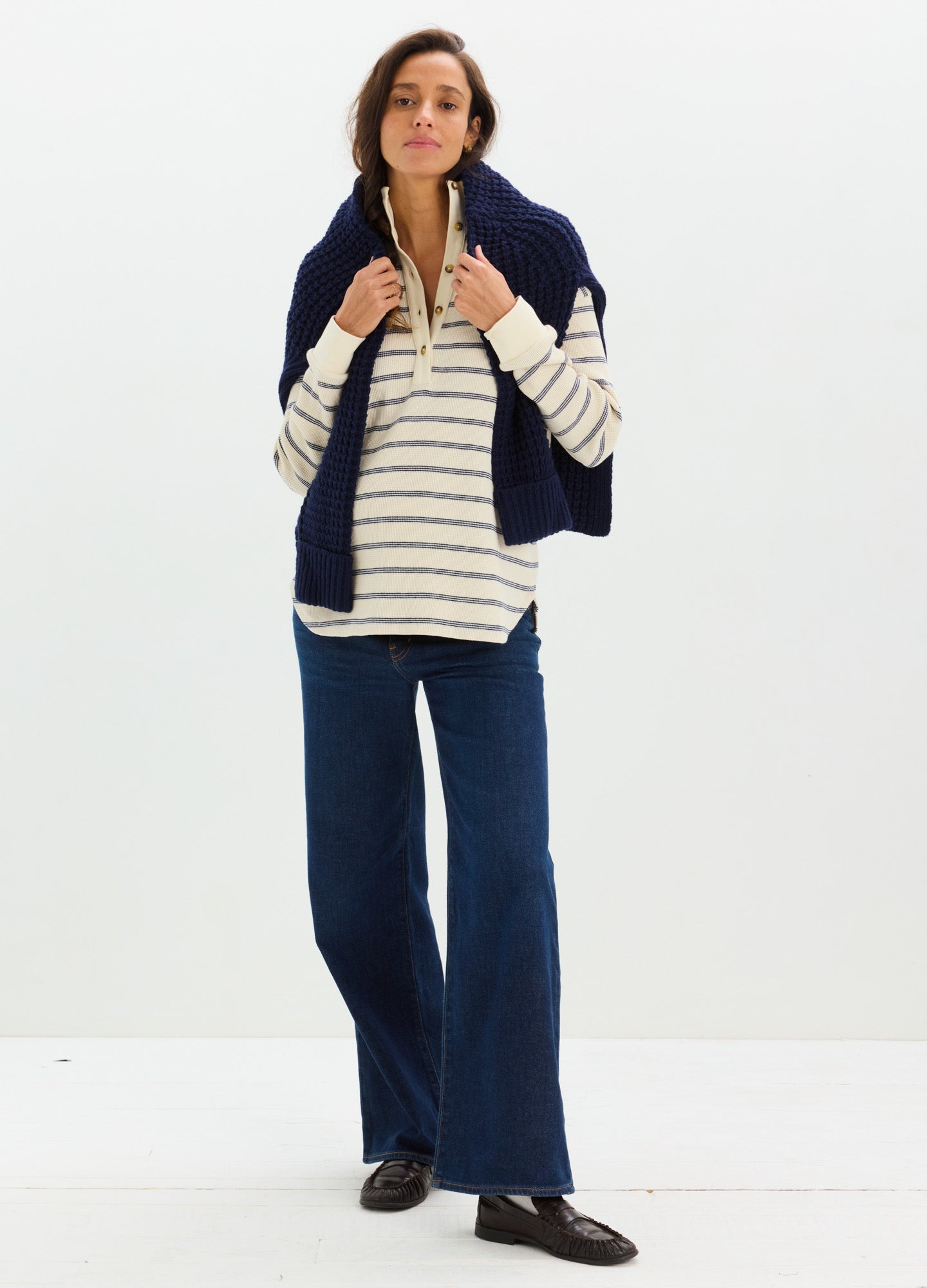 Cream and navy striped waffle knit maternity nursing top with long sleeves, styled with dark blue wide-leg pants and a navy.