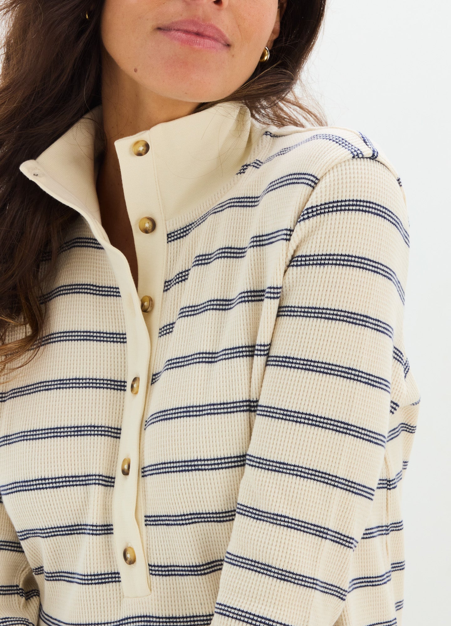 Cream waffle-knit nursing dress with navy horizontal stripes and button-up front collar.