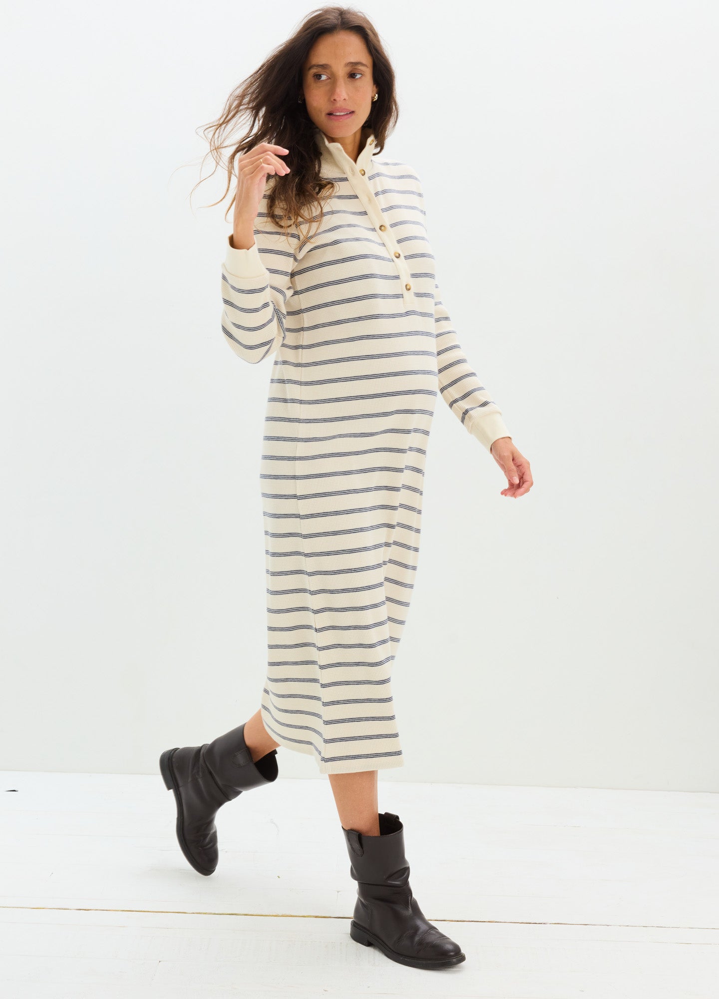 Cream waffle-knit midi nursing dress with black horizontal stripes, long sleeves, and a relaxed fit suitable for maternity.