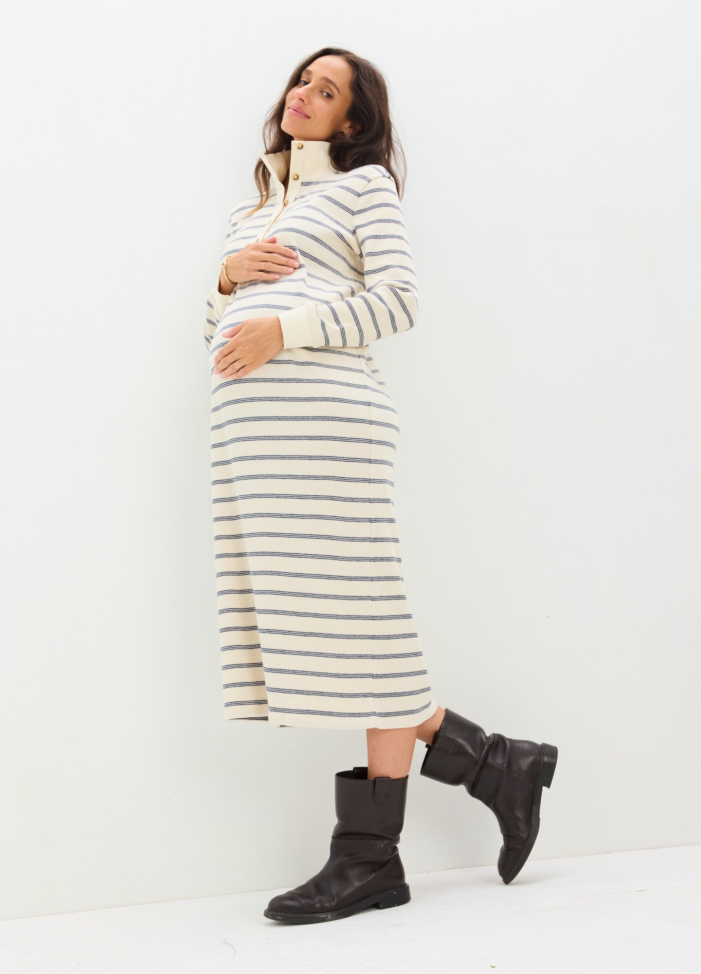 Cream and black striped waffle-knit midi nursing dress with long sleeves and a relaxed fit, styled for maternity.