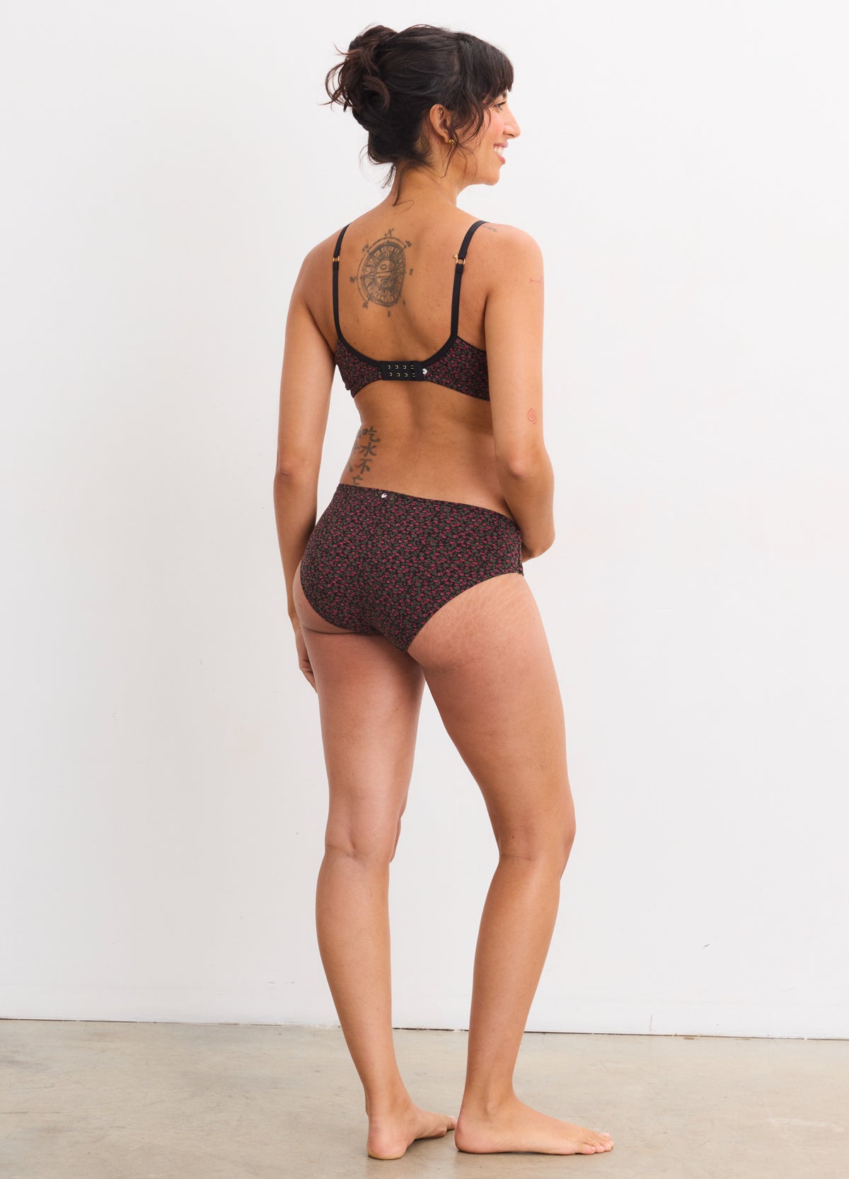 Pregnant woman wearing Demi Fleur Bordeaux maternity bra and matching briefs with delicate lace detailing.