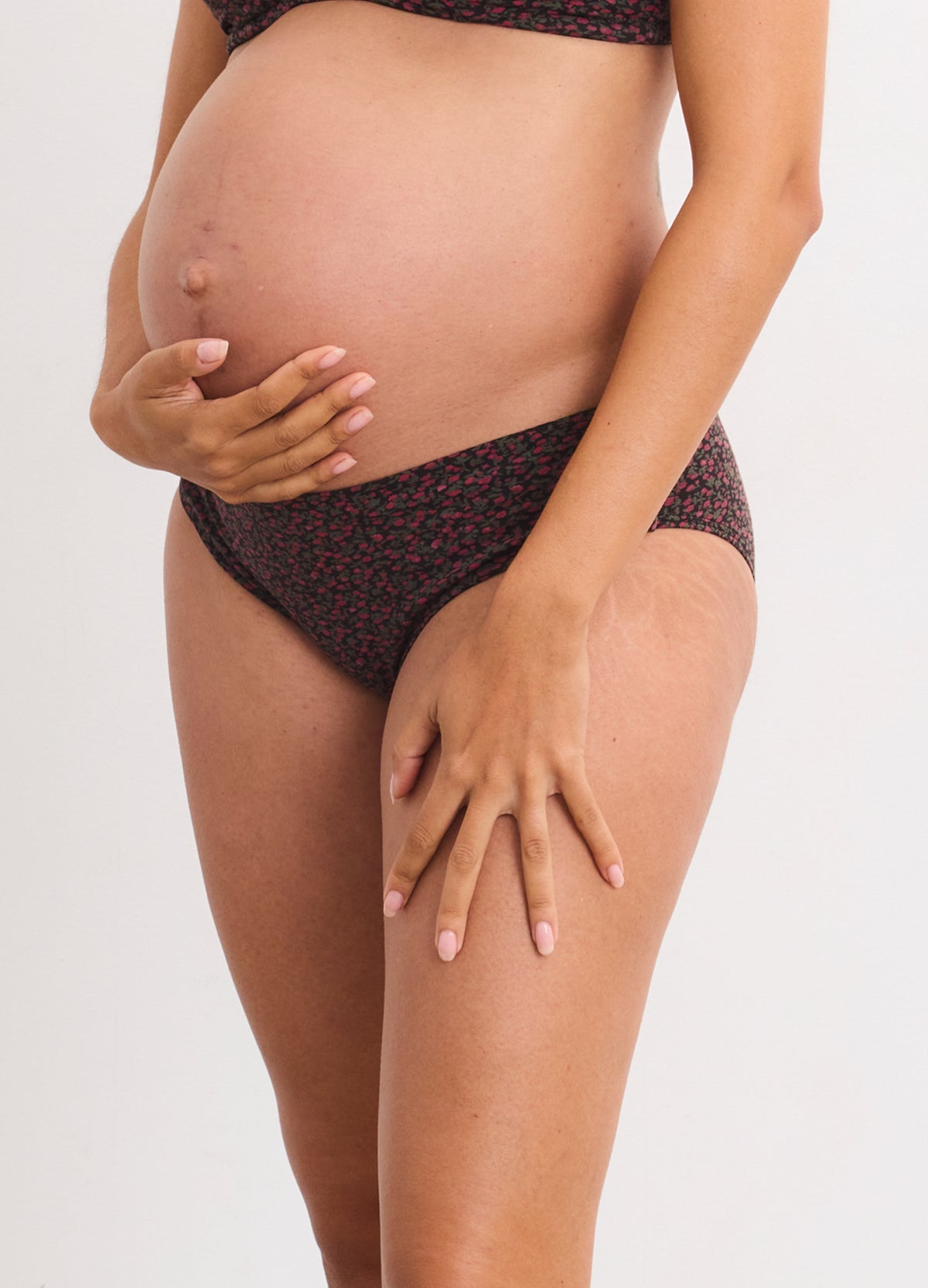 Black maternity briefs with subtle red leopard print, soft fabric, mid-rise cut designed for pregnancy comfort.