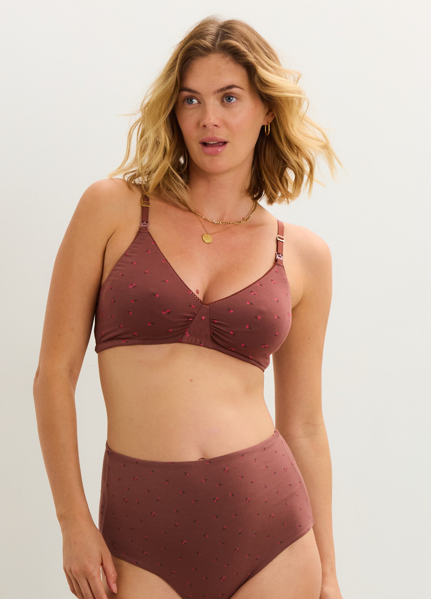 Soft rust-colored maternity nursing bra with adjustable straps and textured fabric.