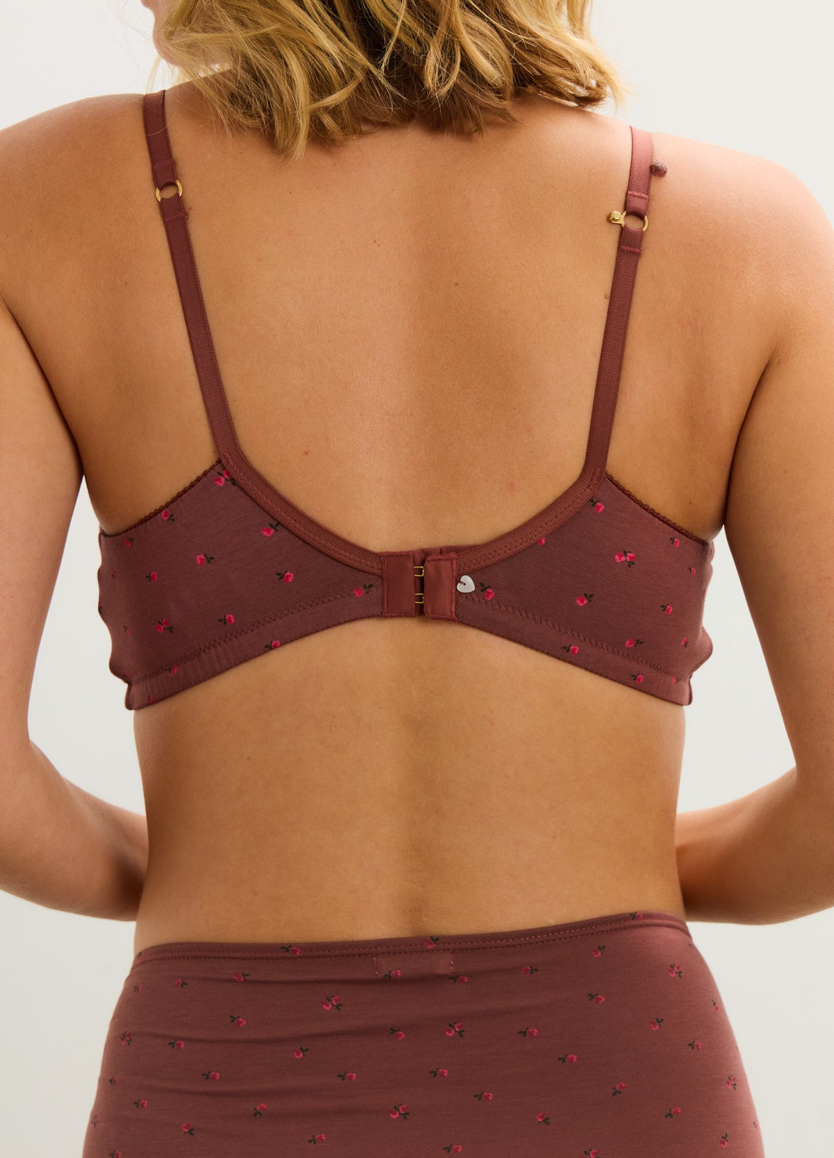Mauve maternity nursing bra with adjustable straps and small embroidered hearts on soft fabric.
