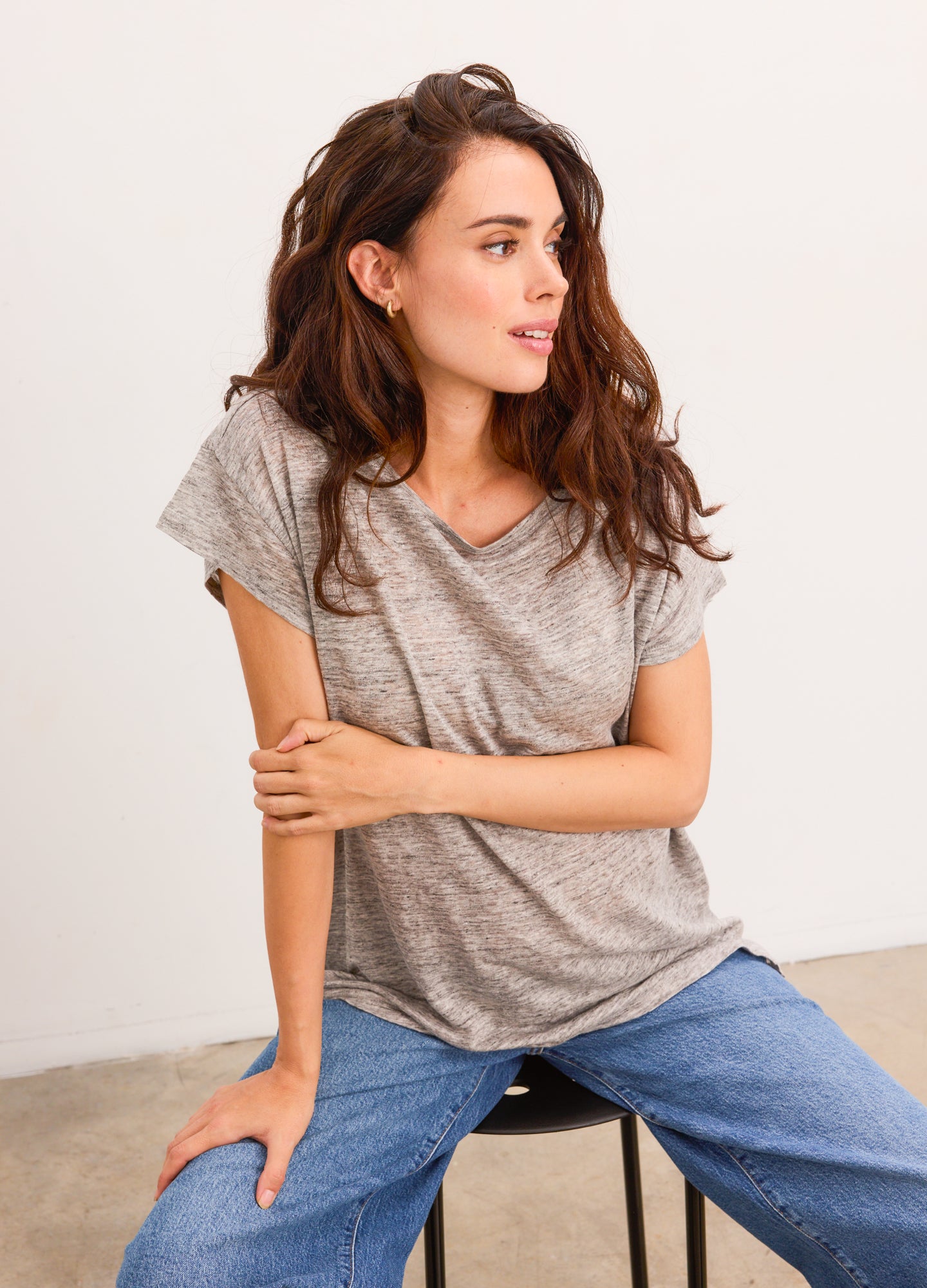 Grey striped short-sleeve maternity linen tee with relaxed fit and v-neckline.