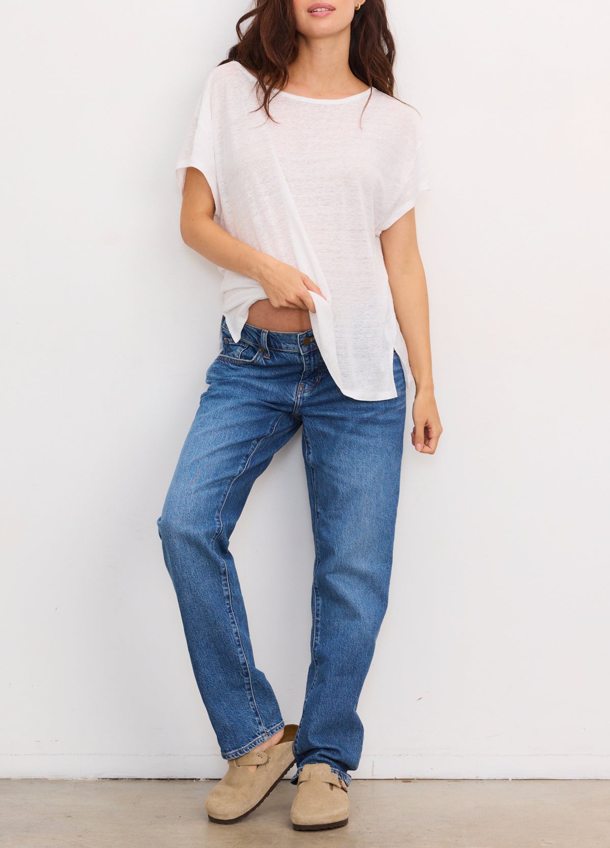 Light grey short-sleeve maternity tee with a round neck and relaxed fit paired with blue jeans.
