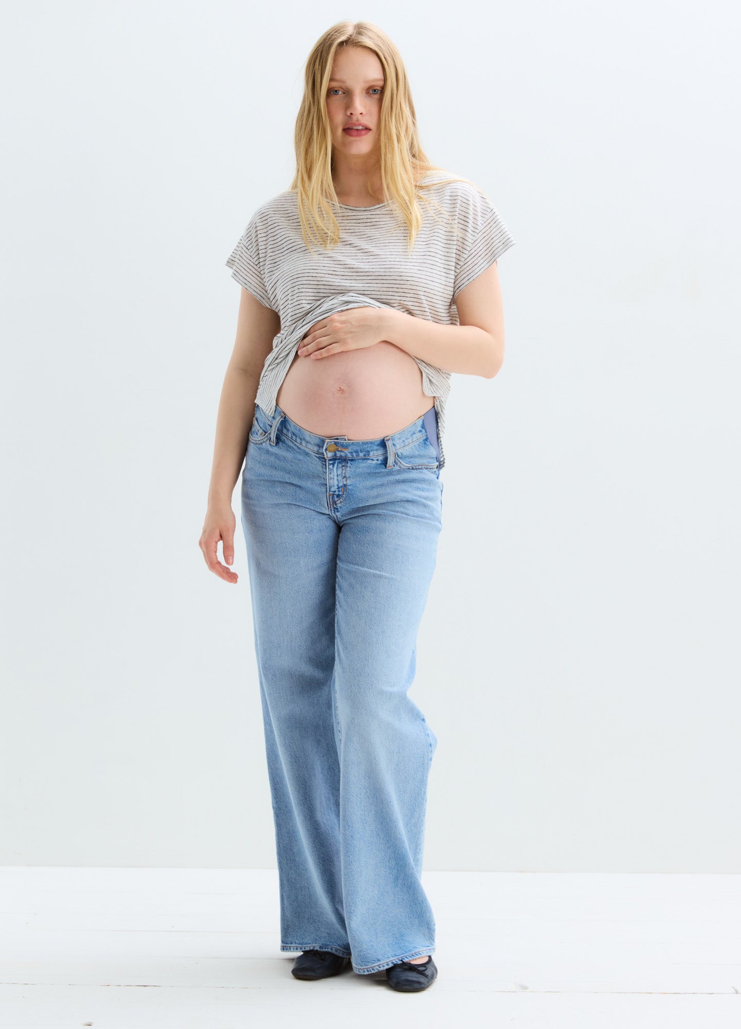 Light blue wide-leg maternity jeans with a relaxed fit and stretchy waistband over the belly.