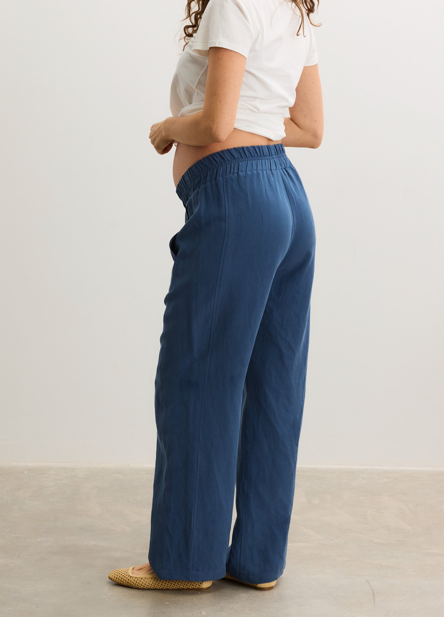 Blue maternity pants with elastic waistband and wide legs, designed for pregnant comfort.