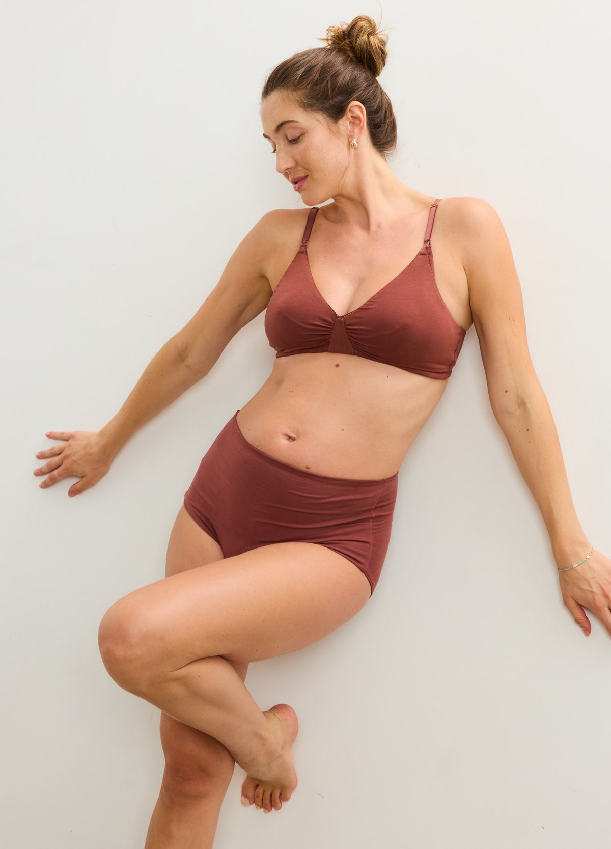 Rust-colored seamless high-waisted maternity brief with soft fabric and smooth edges.