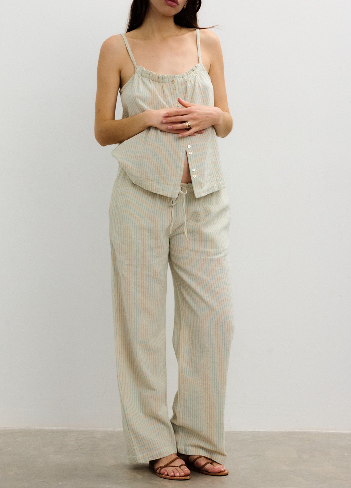 Light beige loose-fit maternity pants with a soft, breathable fabric and an elastic waistband designed for pregnant comfort.