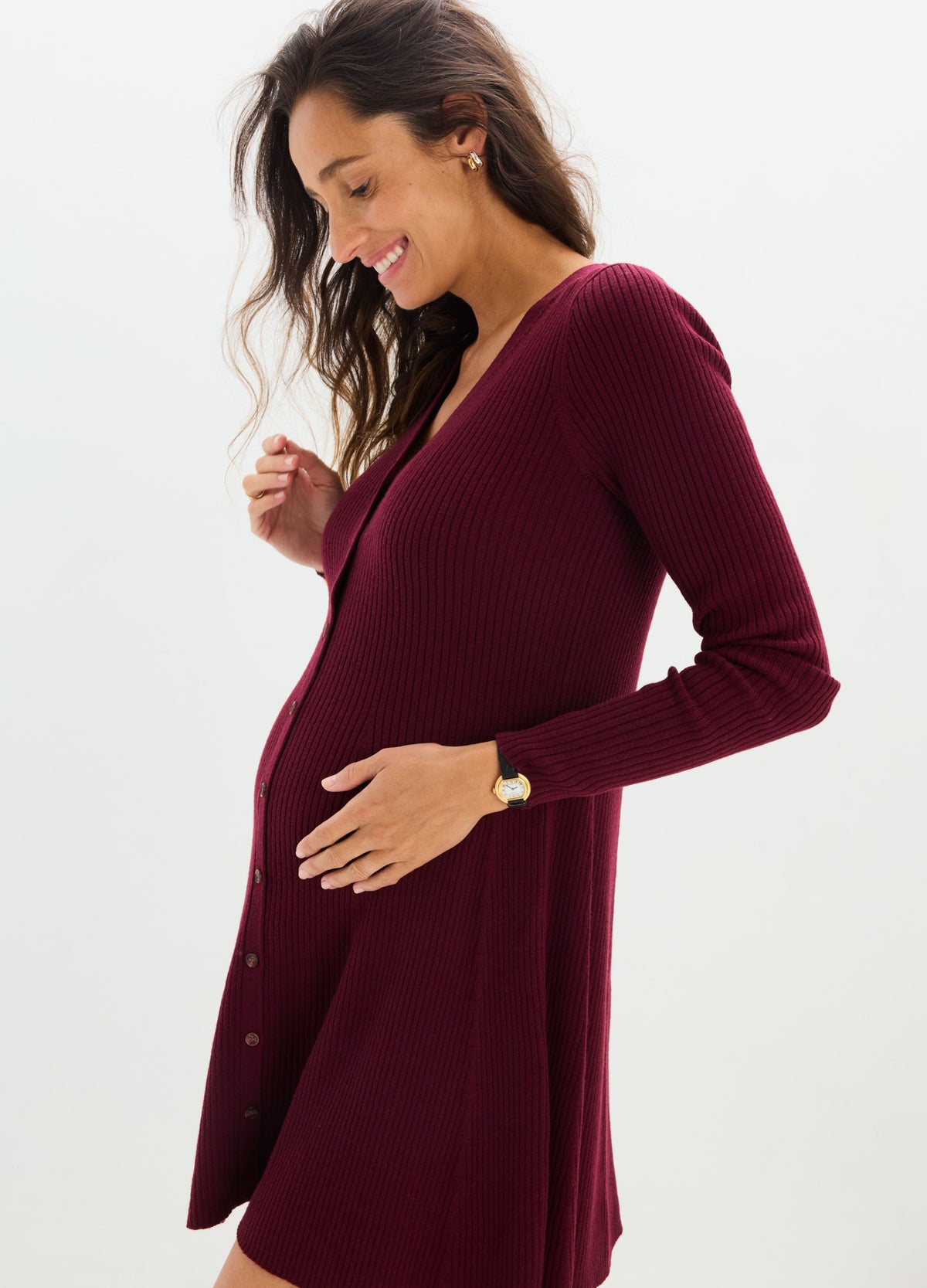 Burgundy knit long-sleeve mini sweater dress with V-neck, designed for maternity wear.