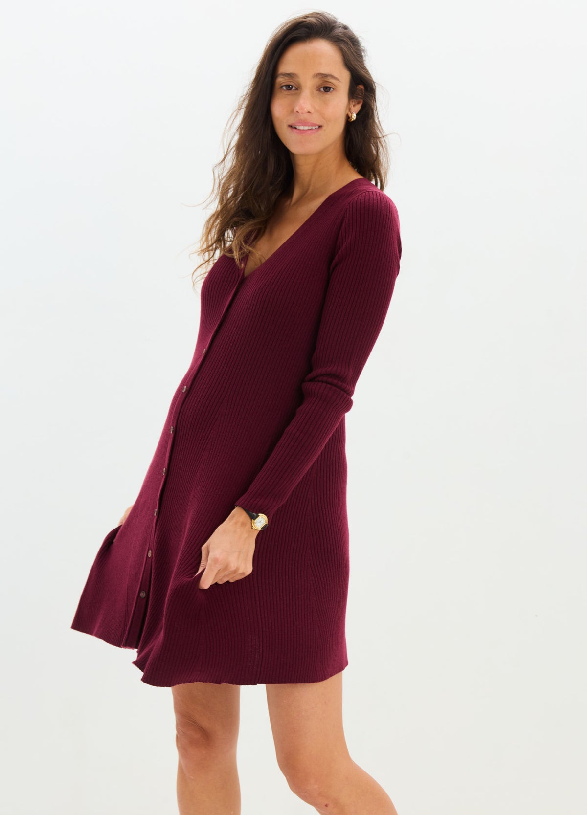 Burgundy ribbed knit mini dress with long sleeves and V-neck, styled for maternity and nursing.