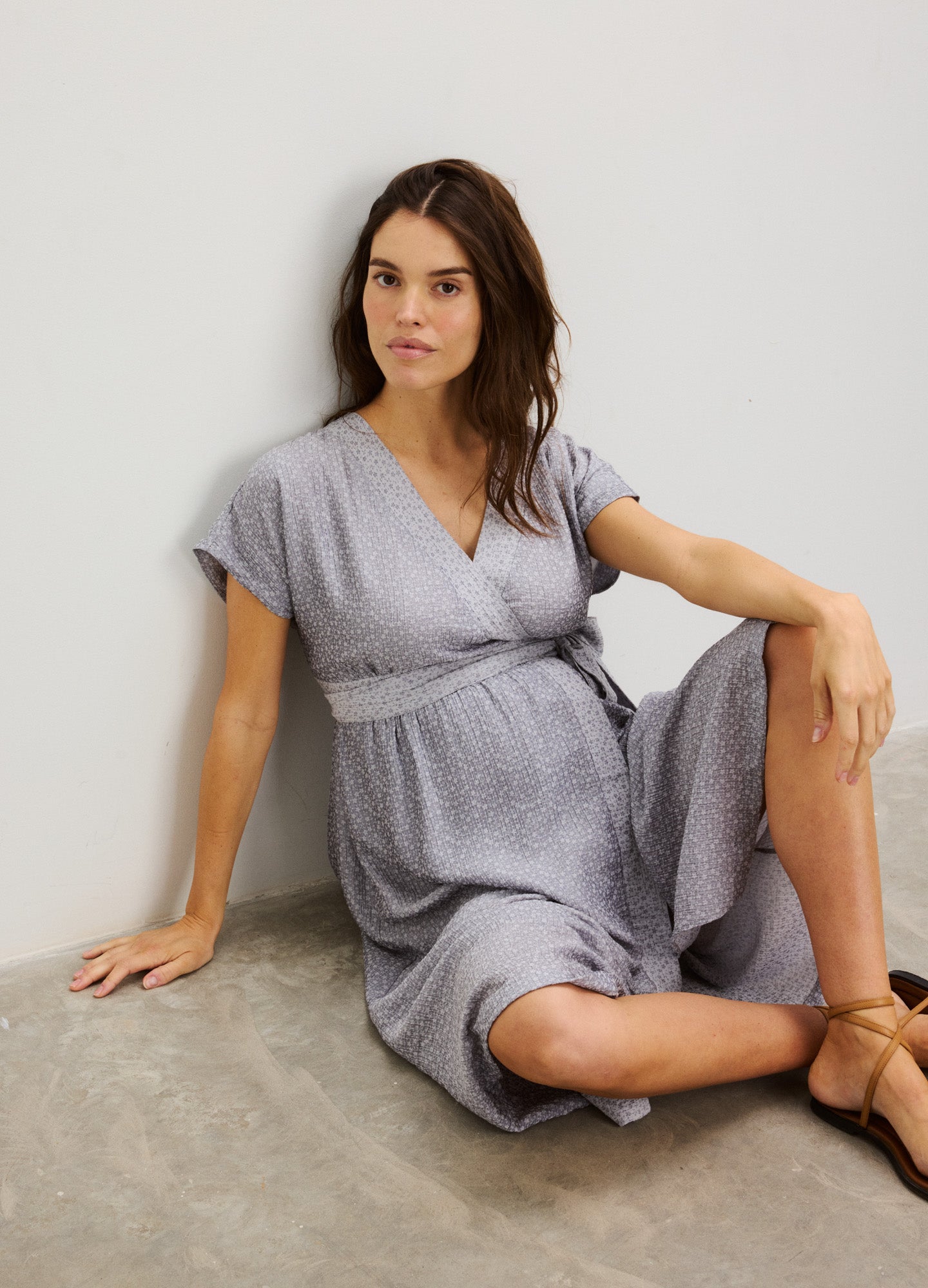 Light gray maternity dress with short sleeves, V-neck, and gathered waist tie.