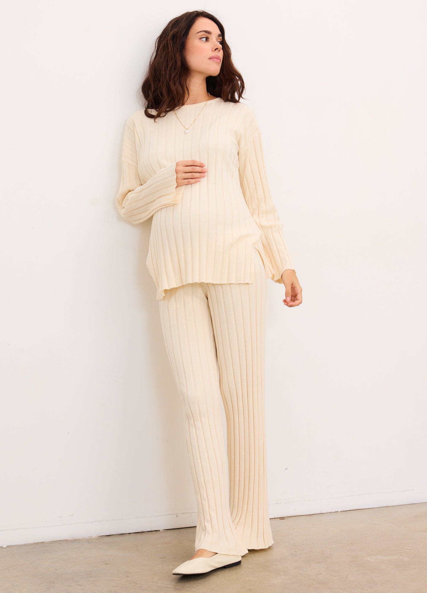 Cream ribbed cotton maternity pullover with matching wide-leg pants, designed for pregnant comfort.