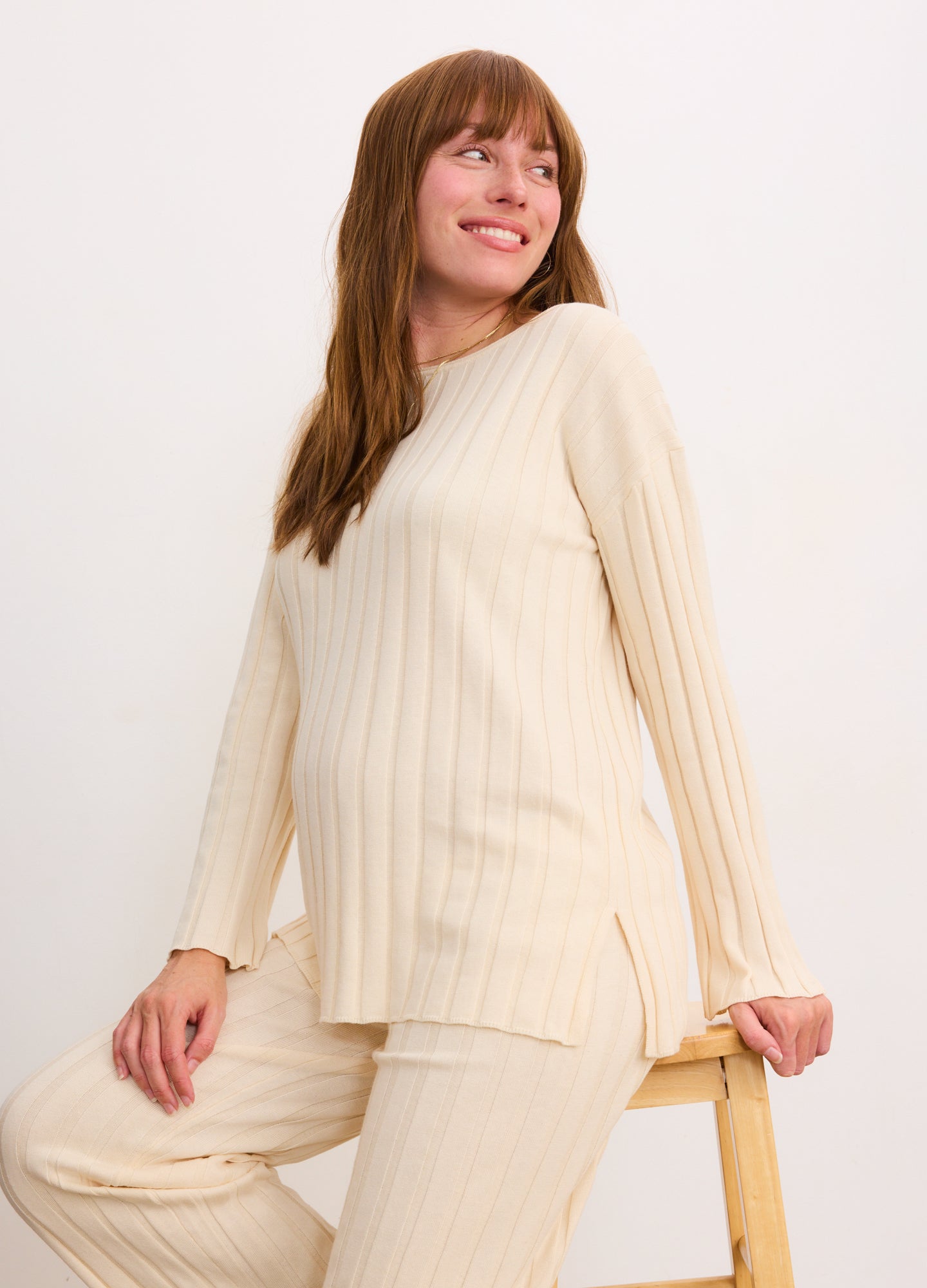 Cream ribbed cotton pullover with long sleeves, loose fit, designed for maternity wear.