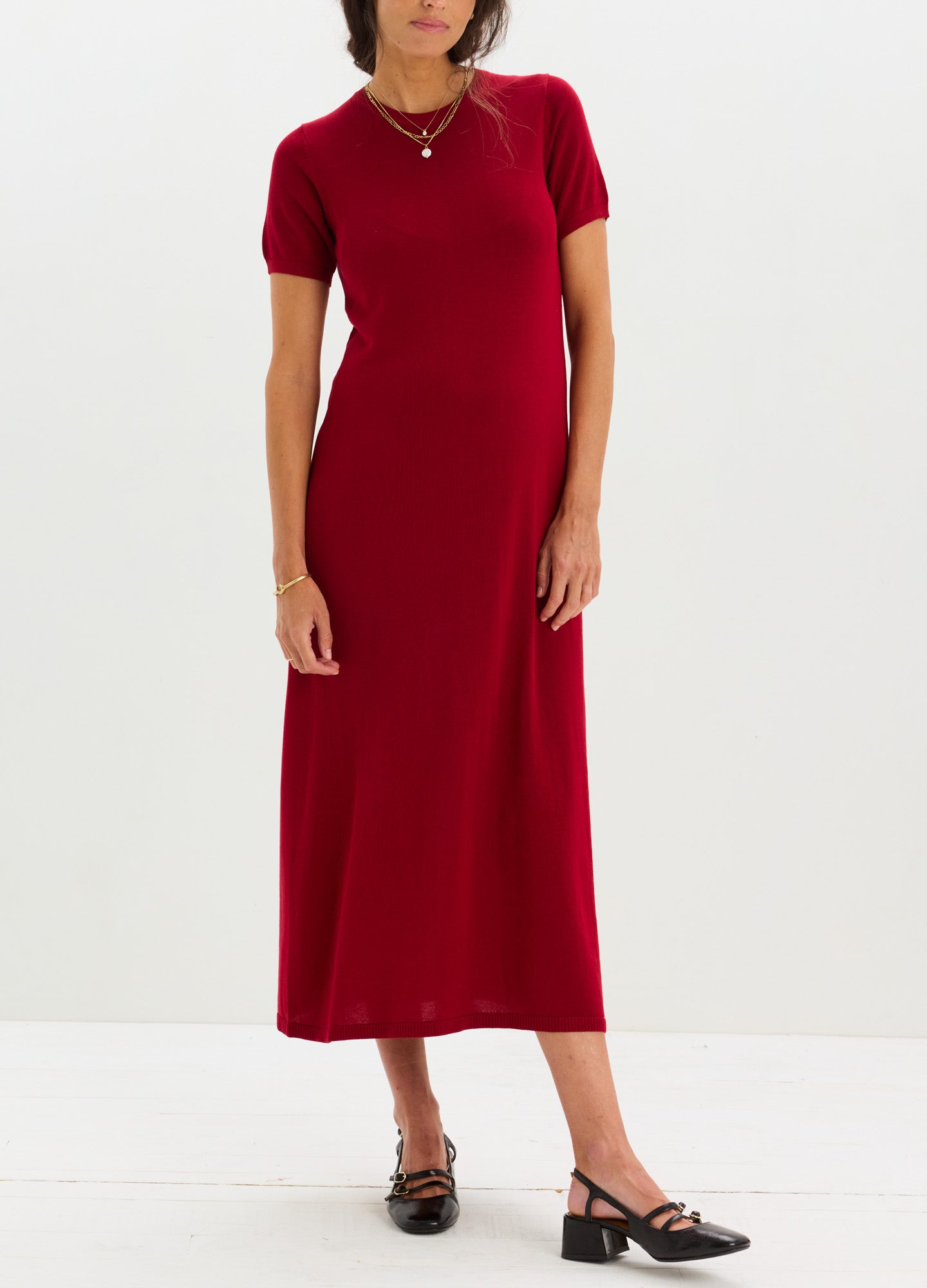 Red short-sleeve knit maternity dress with a fitted silhouette and crew neckline.