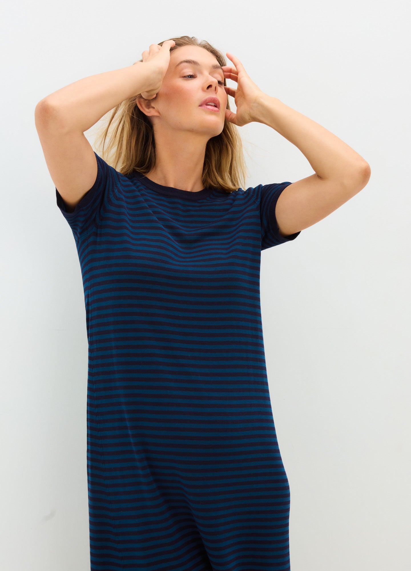 Navy and black striped short-sleeve knit maternity dress with a relaxed fit and crew neckline.