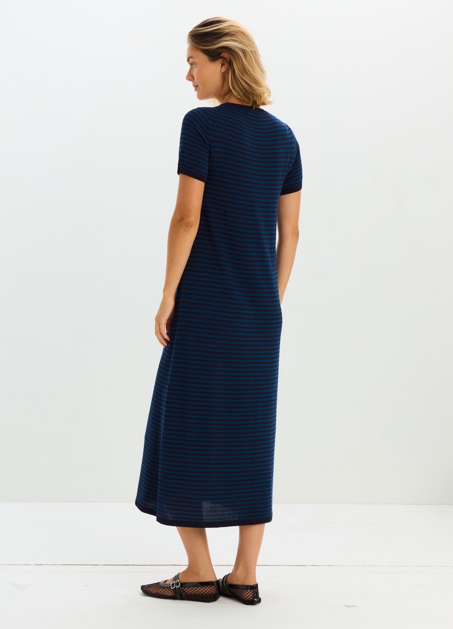 Navy blue maternity knit dress with short sleeves and midi length, designed for pregnant comfort.