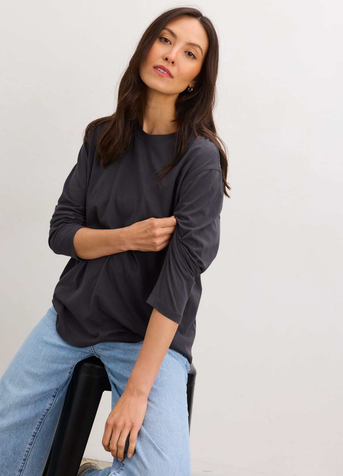 Maternity washed black cotton long sleeve t-shirt on pregnant model with ruched side details.