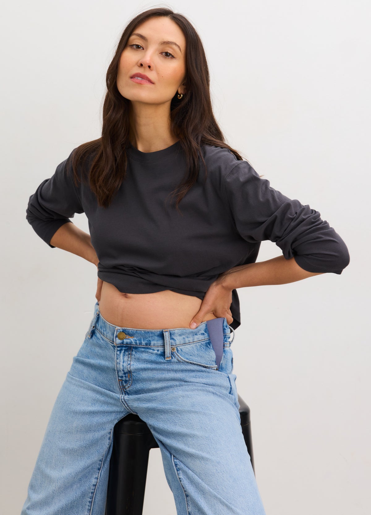 Washed black long sleeve maternity t-shirt with soft cotton fabric worn by pregnant woman.
