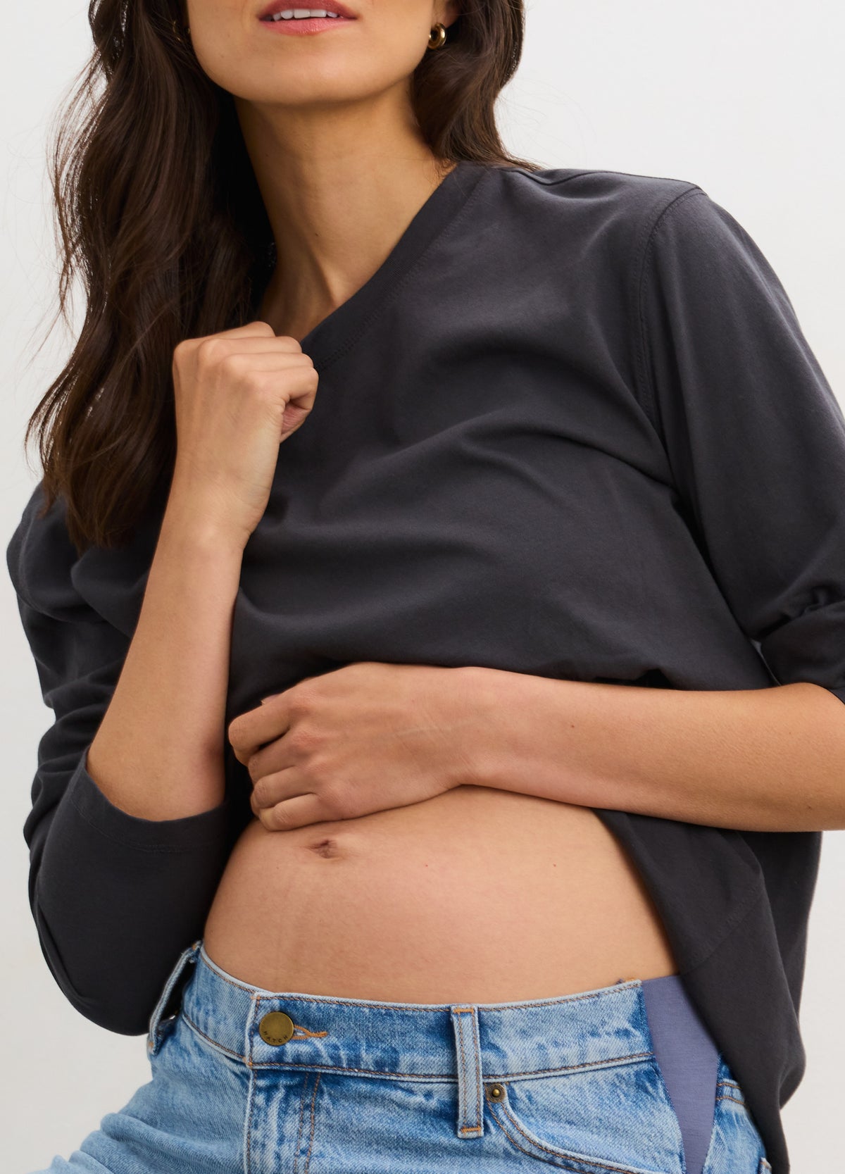 Black washed cotton long sleeve maternity t-shirt with relaxed fit on pregnant model.
