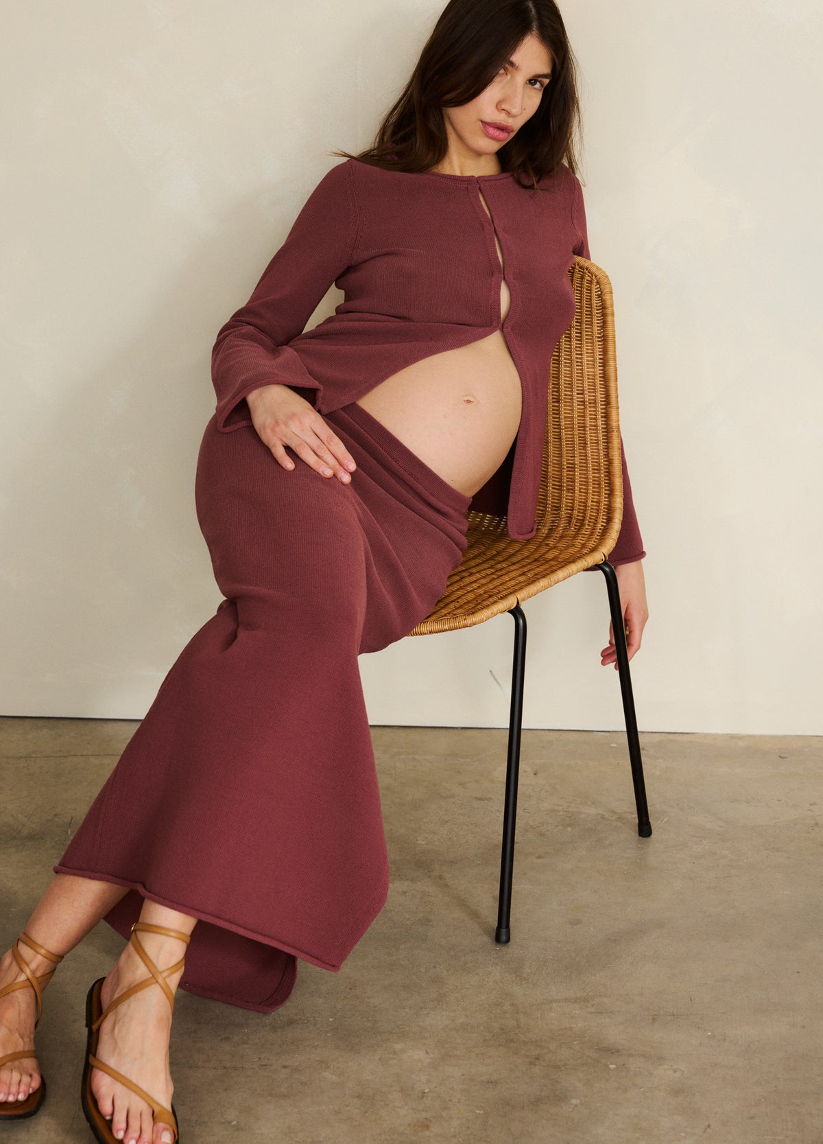 Mauve ribbed knit maternity top with front buttons and matching maxi skirt worn by pregnant woman.