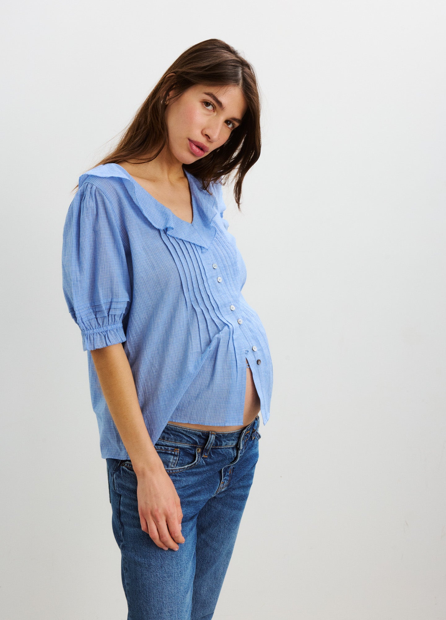 Light blue plaid nursing blouse with puff sleeves, button front, and loose maternity fit.