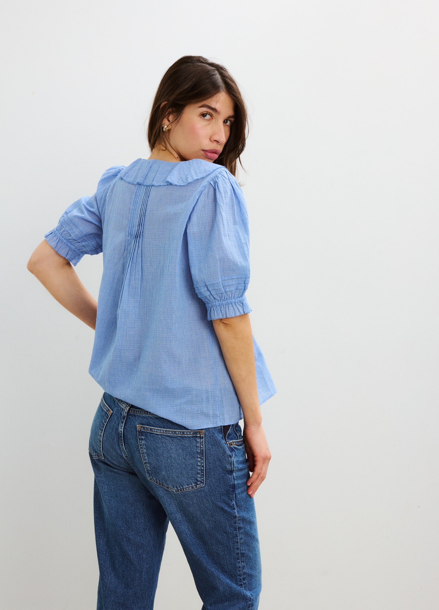 Light blue plaid blouse with puffed short sleeves and nursing access, worn with jeans.