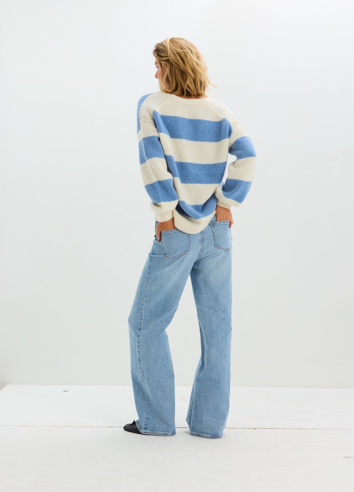 Soft knit maternity cardigan with wide horizontal cream and blue stripes, balloon sleeves, and relaxed fit.